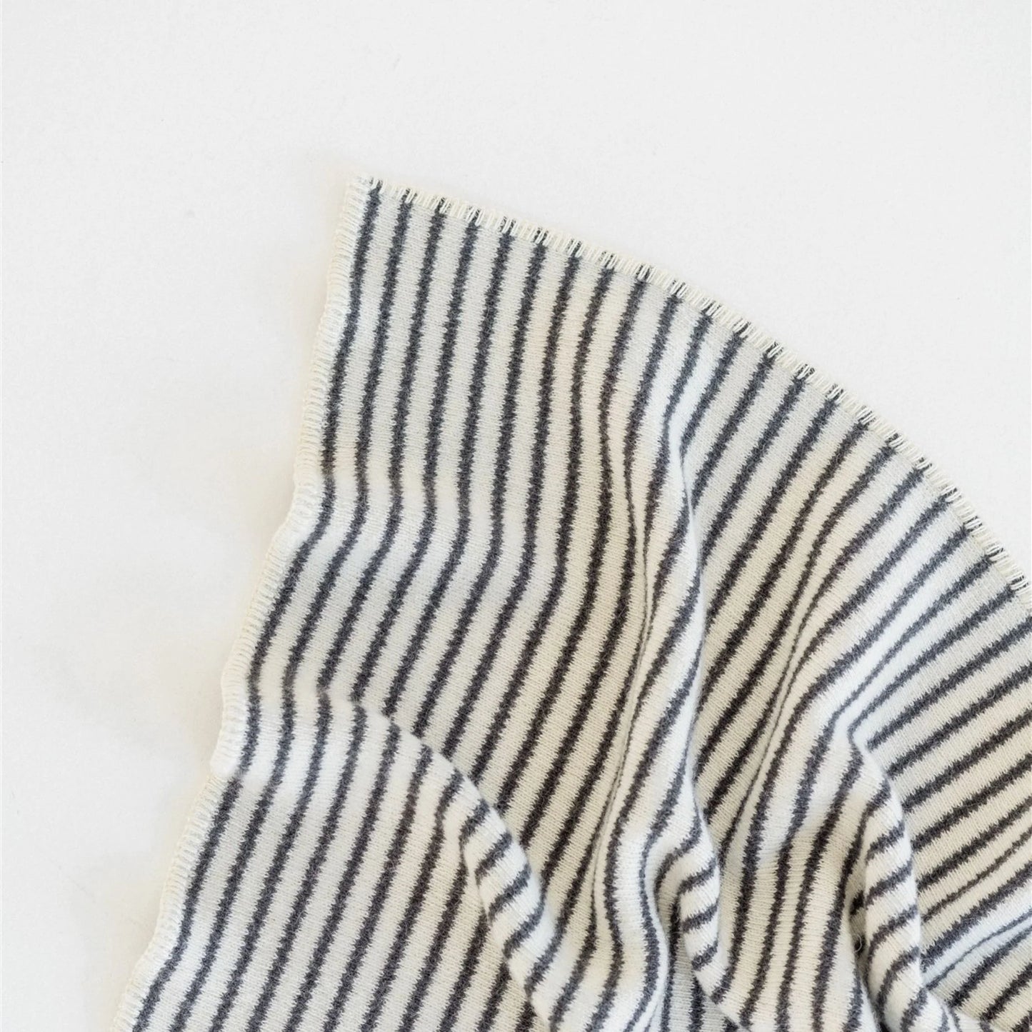 Close-up of a striped fabric with black and white lines on a light background