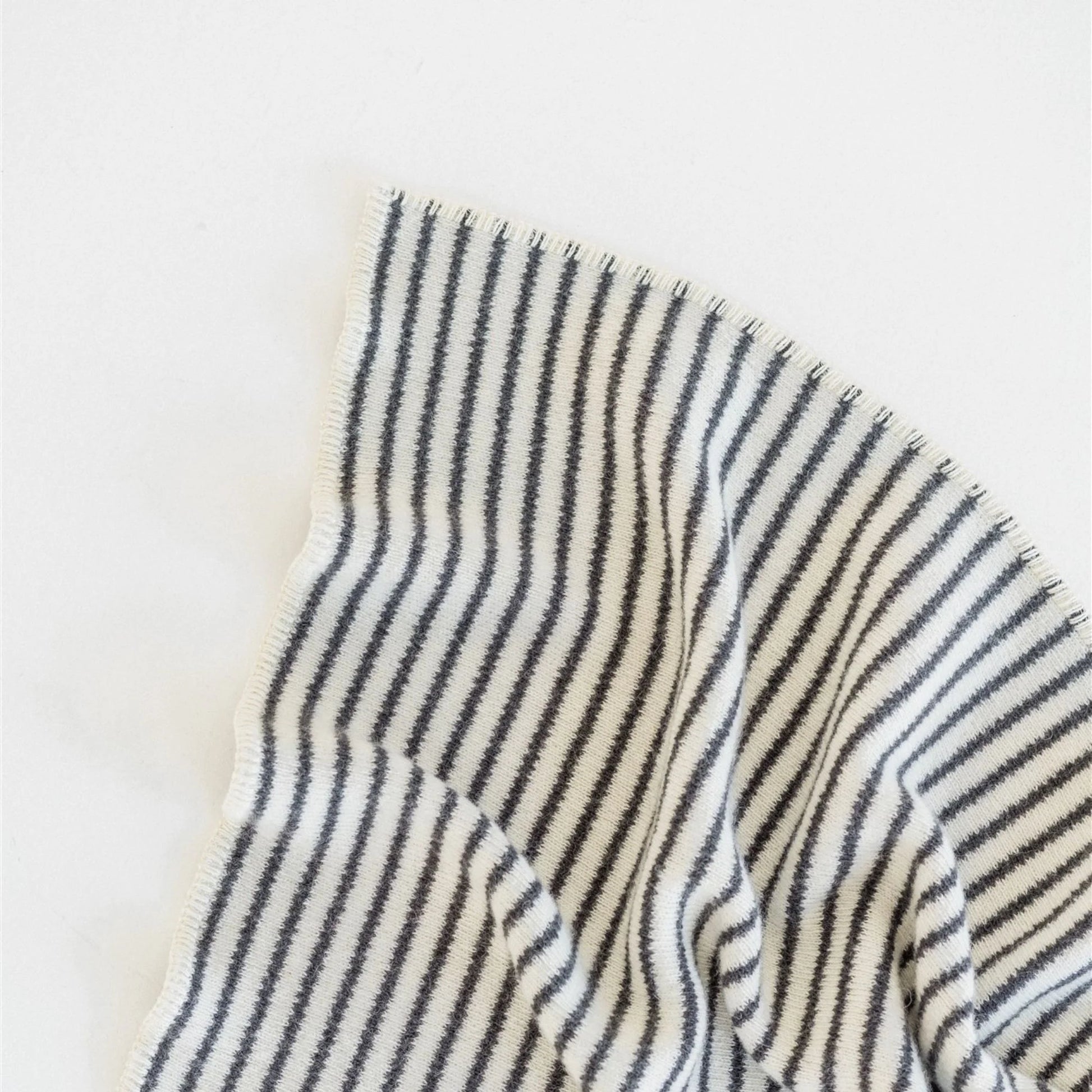 Close-up of a striped fabric with black and white lines on a light background