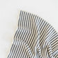 Close-up of a striped fabric with black and white lines on a light background