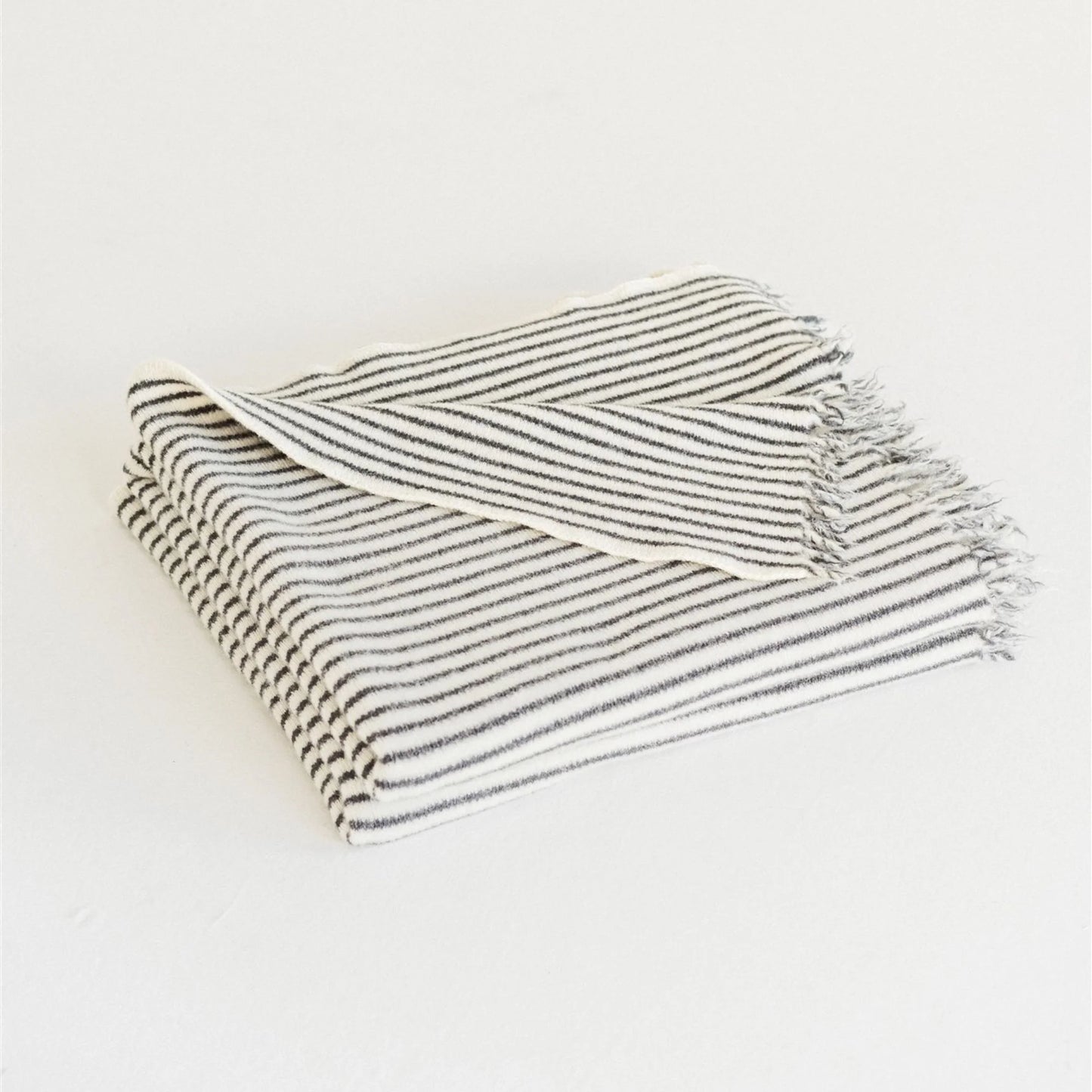 Striped towel with fringes on a white background