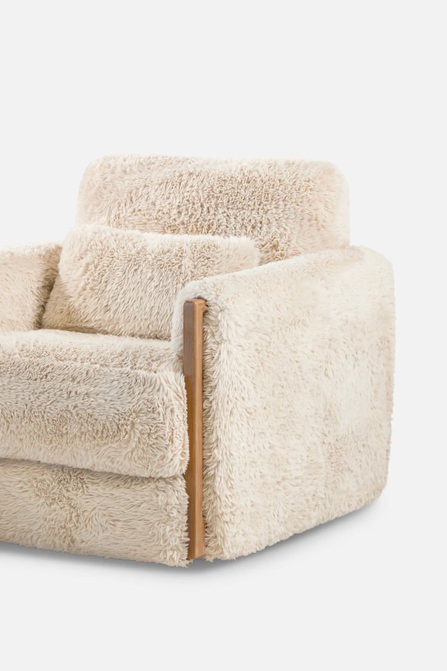Beige faux sheepskin armchair with wooden armrests on a white background