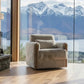 Beige fluffy armchair in a room with a large window view of mountains and water.