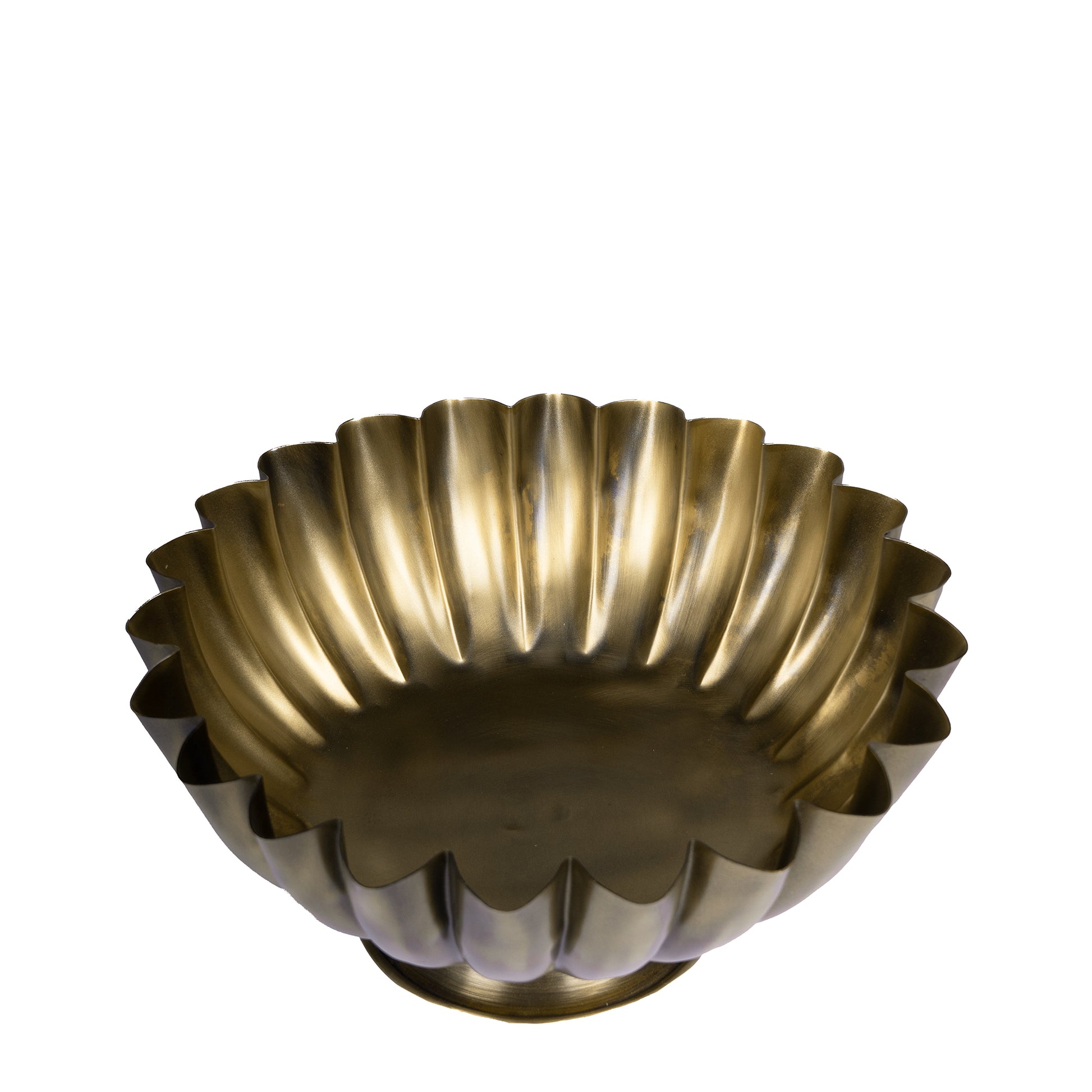 Decorative brass bowl with fluted design on a white background