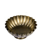 Decorative brass bowl with fluted design on a white background