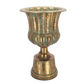 Decorative brass urn with ribbed design on a white background