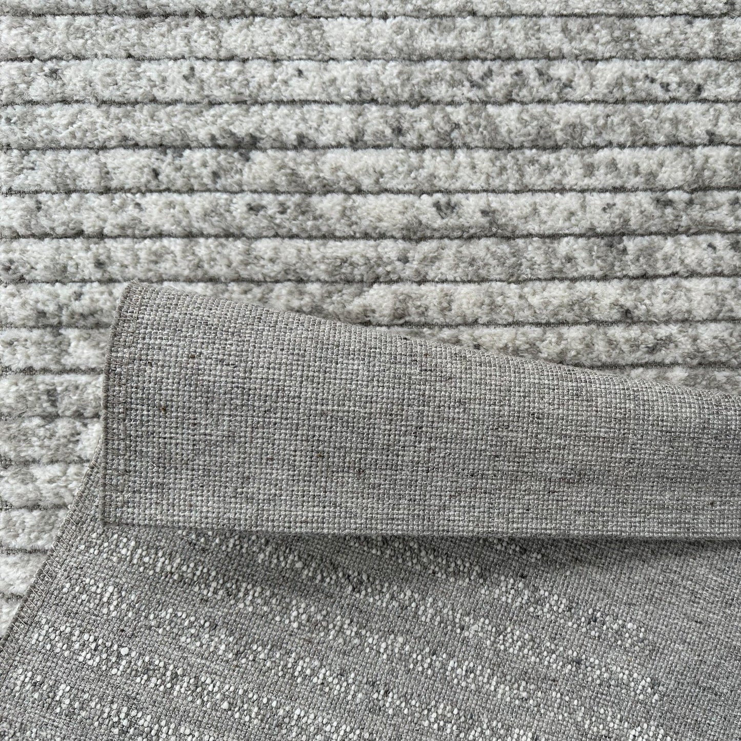 Close-up of textured gray fabric with a patterned surface
