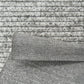 Close-up of textured gray fabric with a patterned surface