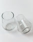Two clear glass tumblers on a white background
