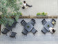 Top-down view of an outdoor seating area with tables and chairs on a tiled patio.