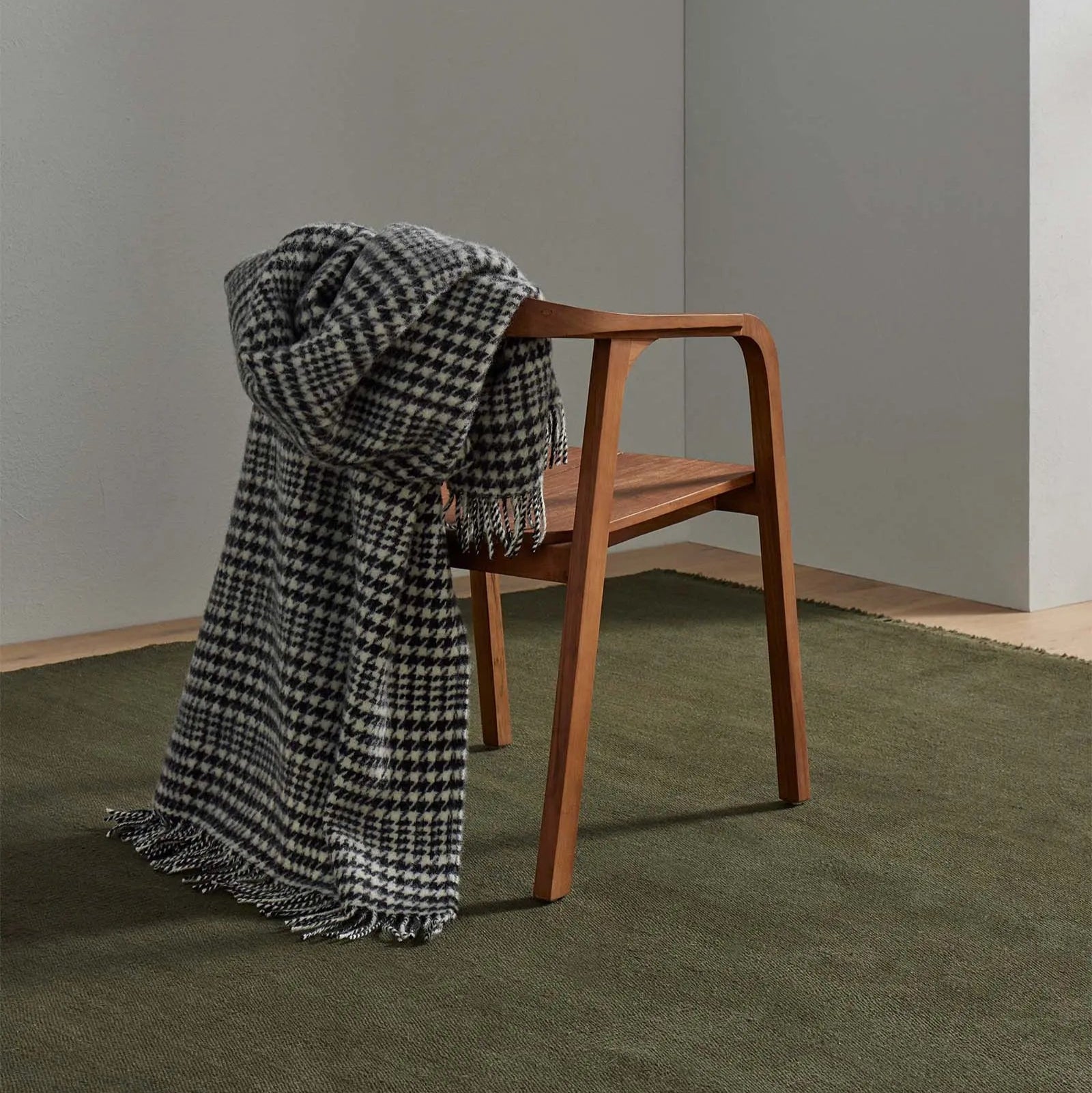 black and white houndstooth check throw over a wooden chair