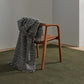 black and white houndstooth check throw over a wooden chair