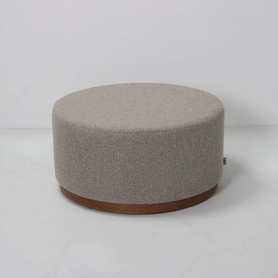 Round gray ottoman with a wooden base on a white background