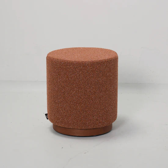 Brown textured cylindrical stool on a light gray background