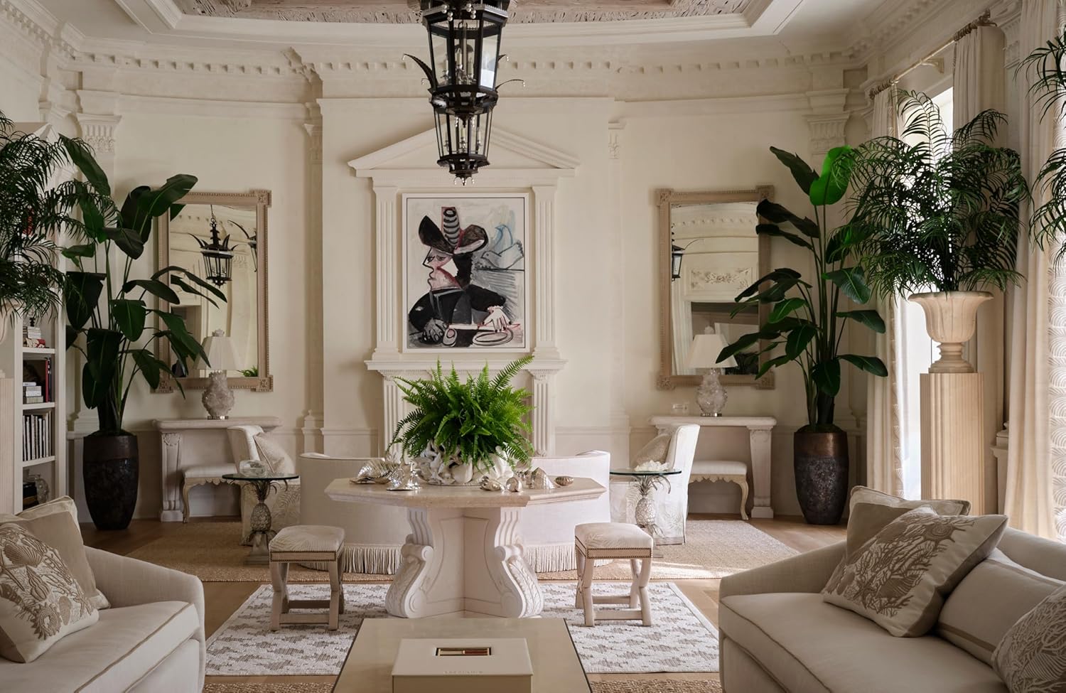 Elegant living room with white furniture, plants, and decorative elements.