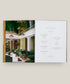 Open book showing a luxurious interior design layout with green sofas and chandeliers.