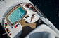 Person lounging by a pool on a yacht deck with a clear sky.