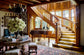 Grand staircase in a luxurious room with wooden paneling and decorative elements.