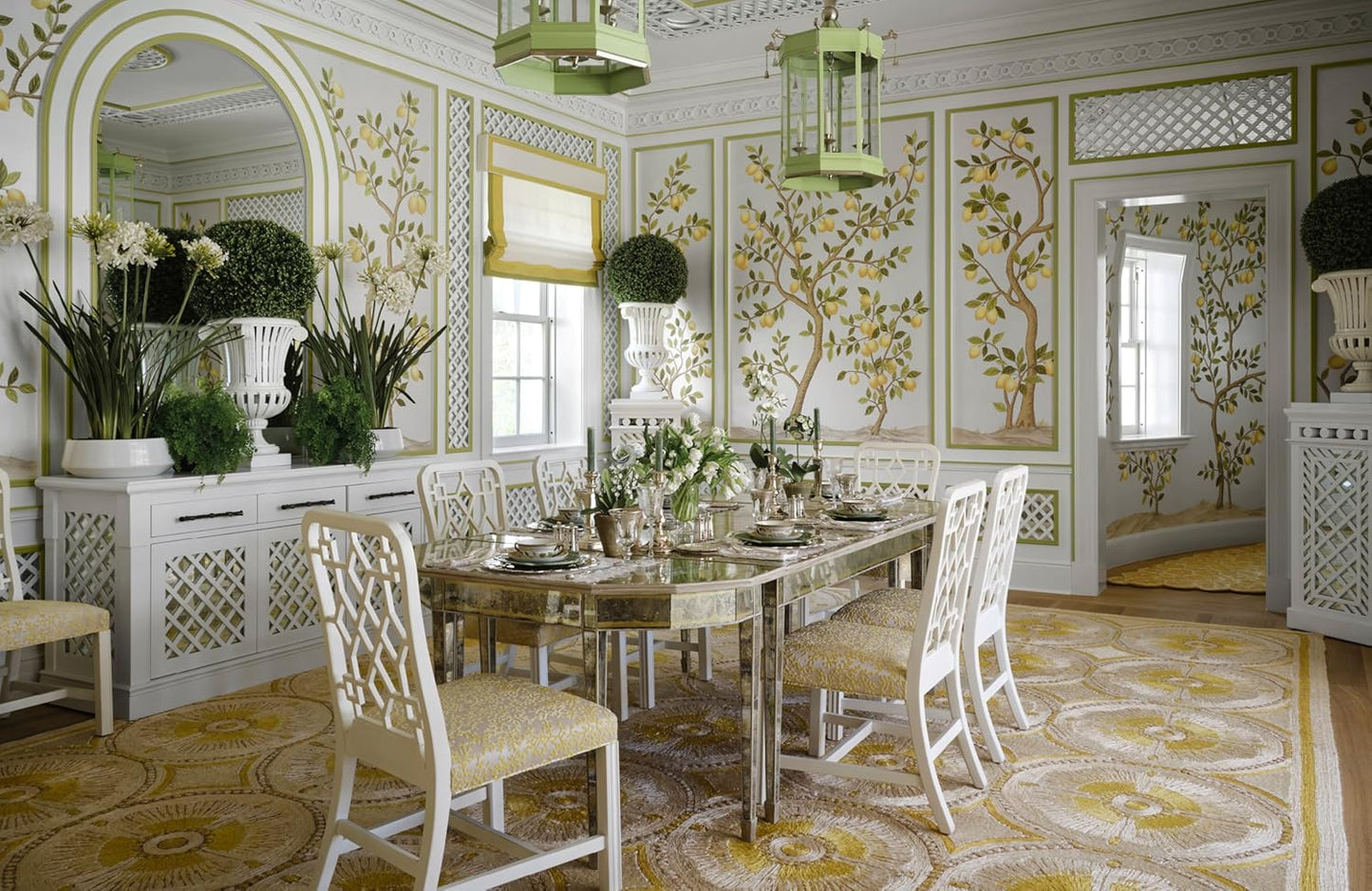 Decorative dining room with ornate walls, table, and chairs.