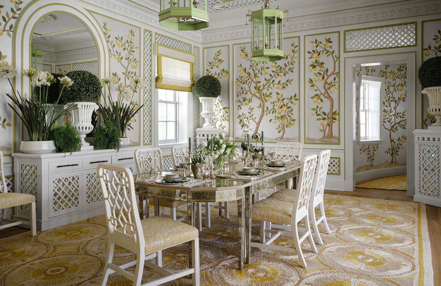 Decorative dining room with ornate walls, table, and chairs.