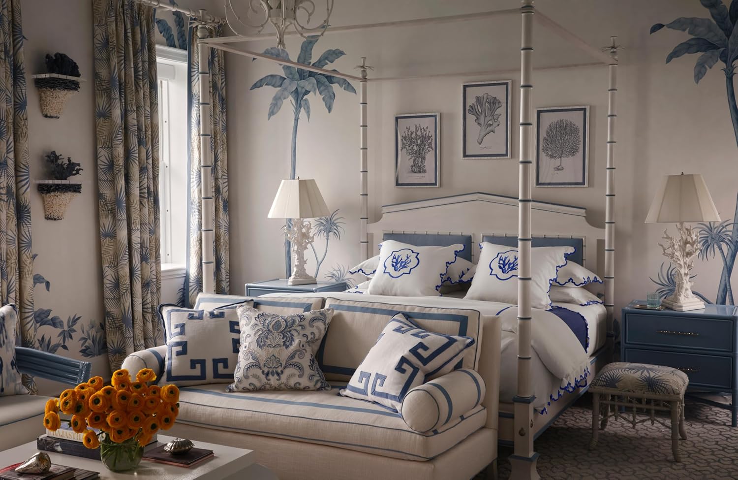 Decorative bedroom with four-poster bed, sofa, and palm tree wall art.