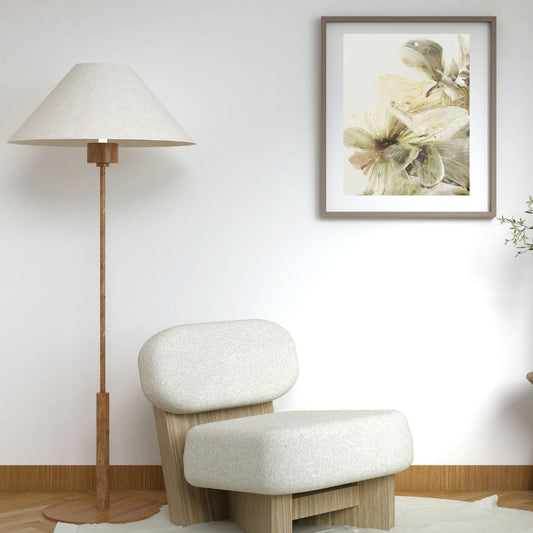 Modern chair with a floor lamp and floral artwork in a room.