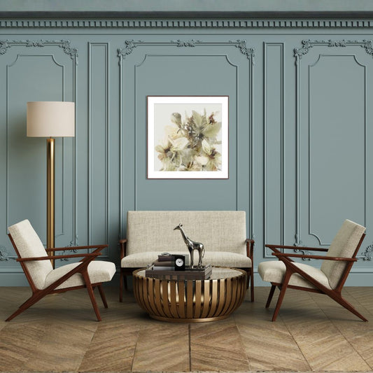 Living room with a sofa, armchairs, and a coffee table against a paneled wall with a floral painting.