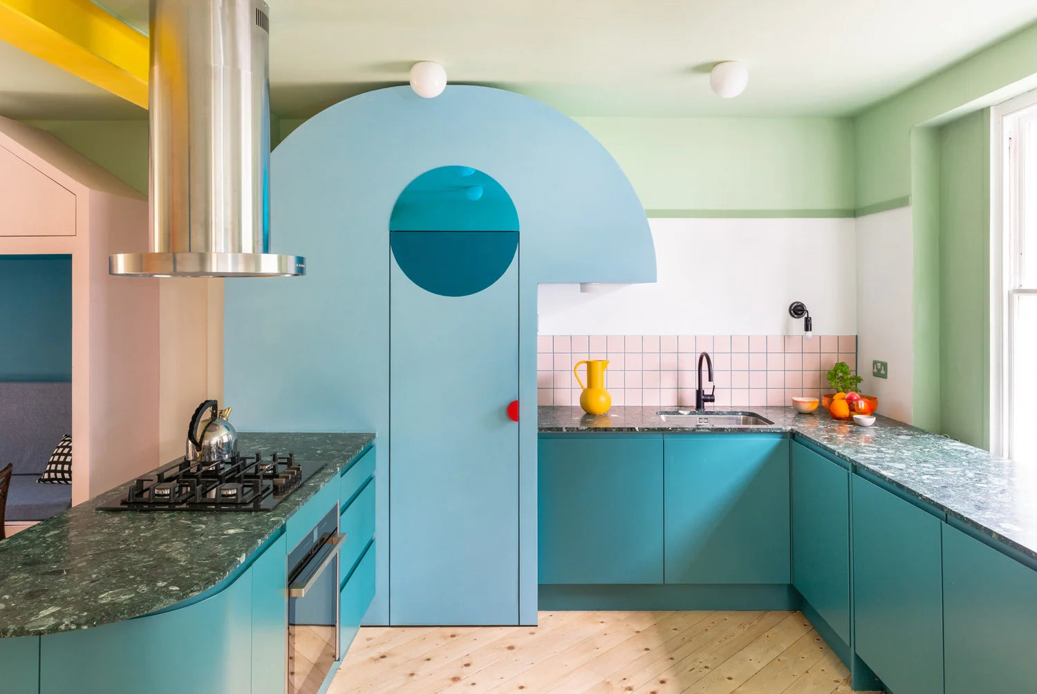 Modern kitchen with blue cabinets and green countertops