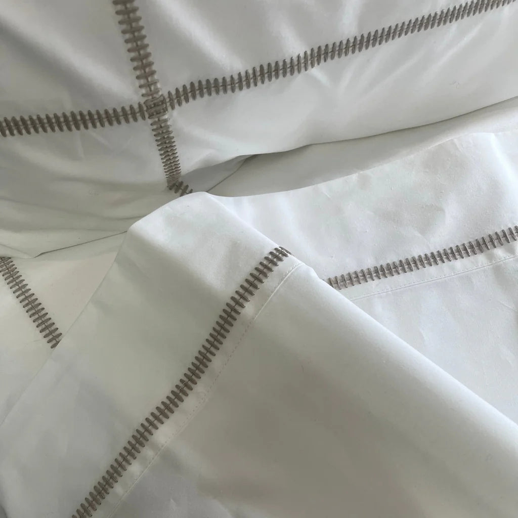 Close-up of white fabric with decorative stitching