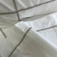 Close-up of white fabric with decorative stitching