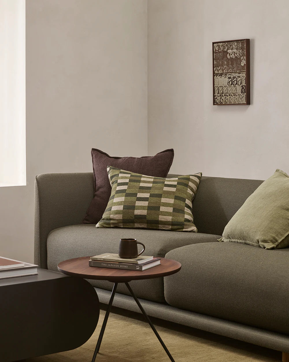 Gray sofa with decorative pillows in a living room setting