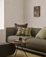 Gray sofa with decorative pillows in a living room setting