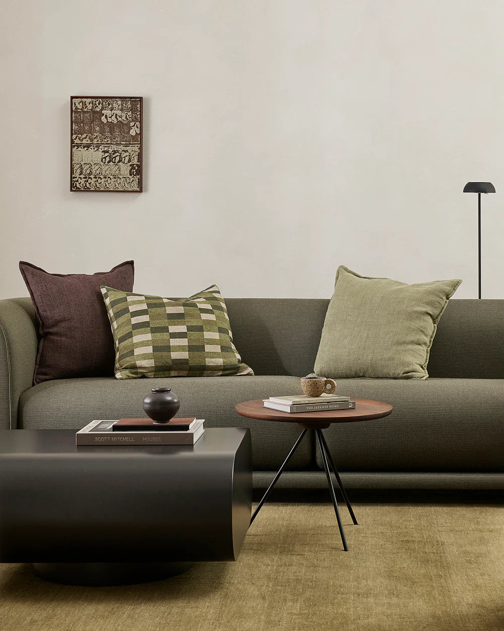 Modern living room with a gray sofa, coffee table, and decorative items.