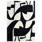 Abstract black and white rug with geometric patterns on a plain background