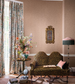Living room with floral curtains, a leopard print sofa, and decorative items.