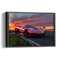 A framed wall art print showing a red supercar on a road at sunset, presented as a rectangular canvas or framed print against a plain white background.