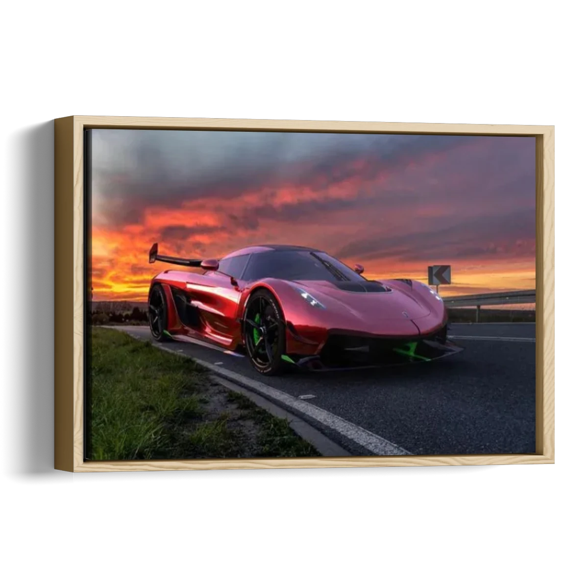 A framed canvas print featuring a red supercar on a highway during a dramatic orange and pink sunset, shown as a 3D gallery-wrapped wall art piece against a white background.