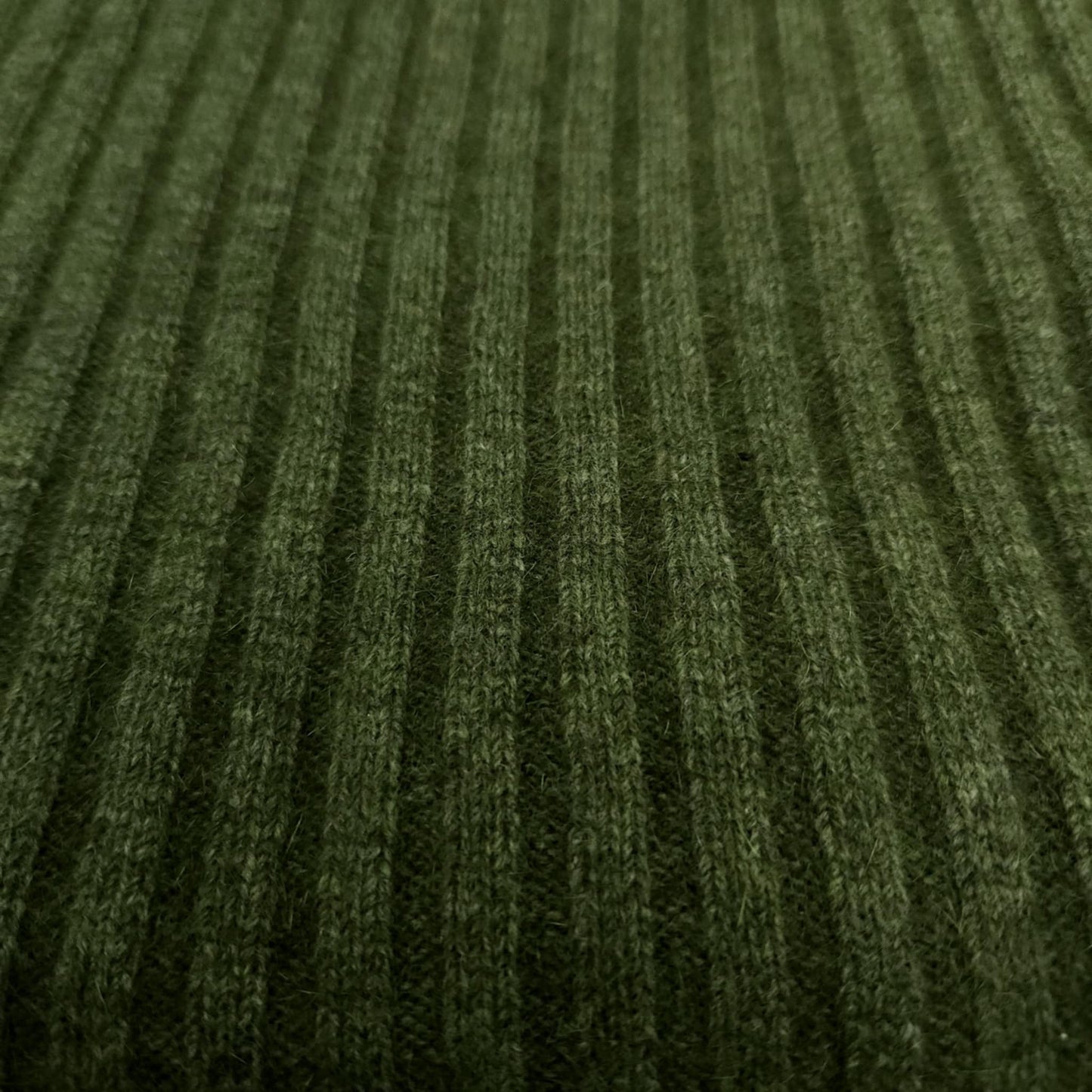 A ribbed throw in moss green,
