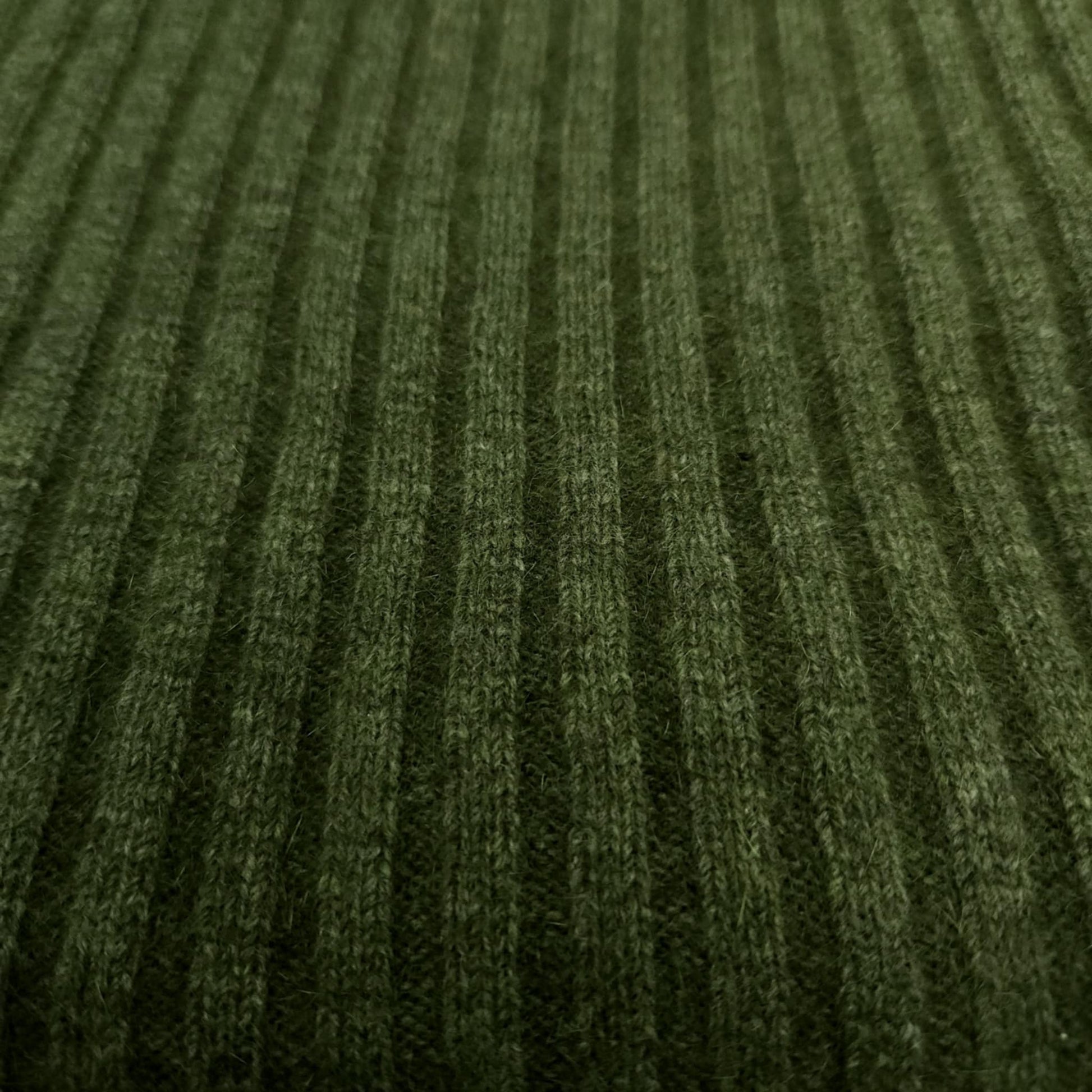 A ribbed throw in moss green,