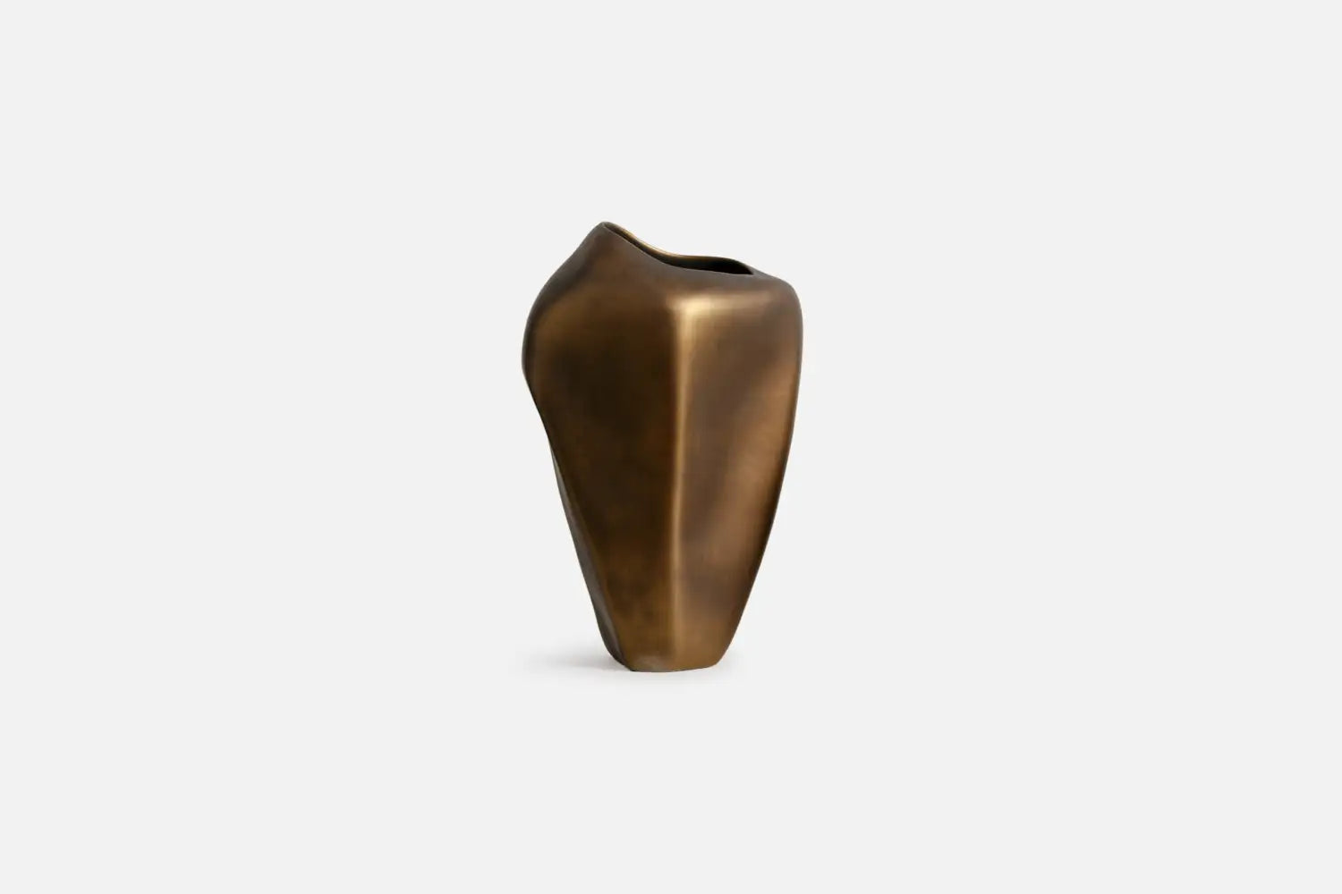 A small sculptural vase with a matte bronze finish, featuring an organic, rounded shape and a wide, open top, set against a plain light gray background.