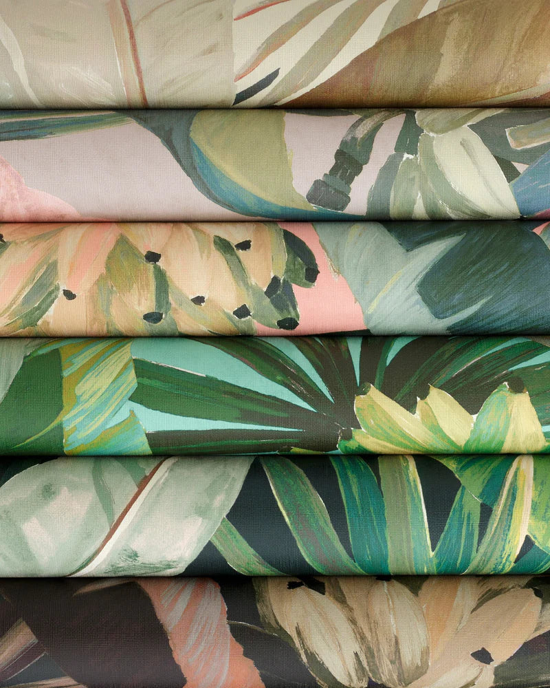 Stack of fabric swatches with tropical leaf patterns