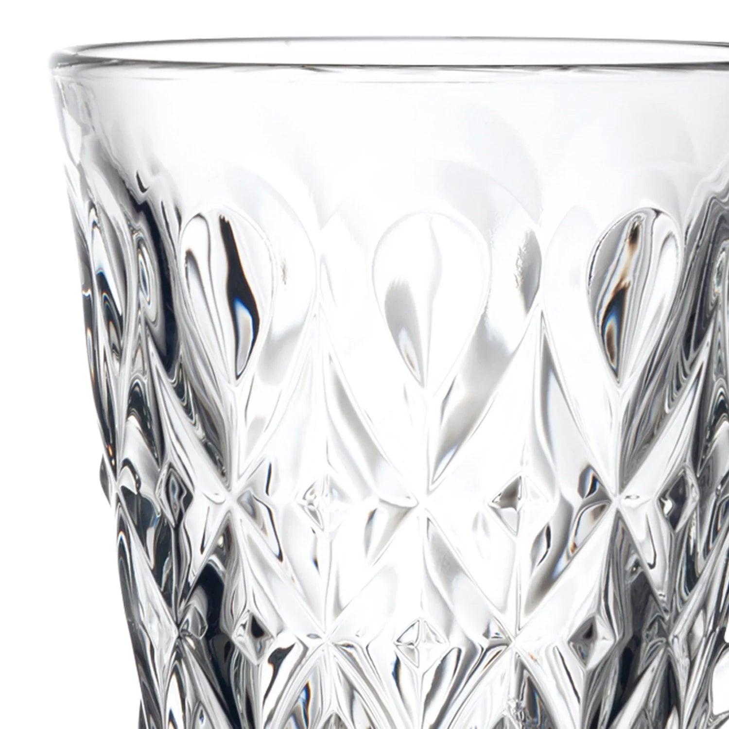 A close-up of a clear cut-glass tumbler with an intricate geometric pattern, shown against a plain white background.