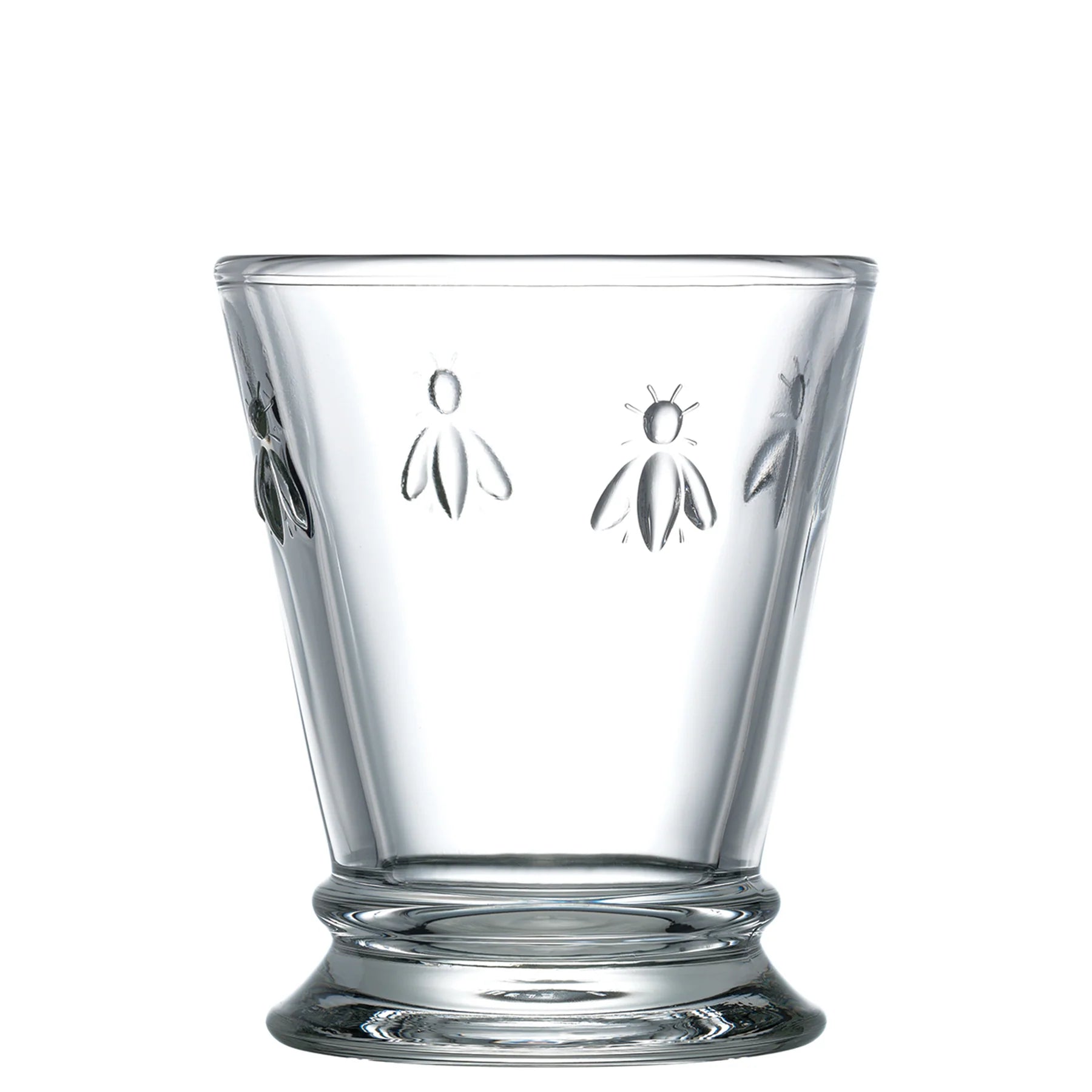Clear glass tumbler with bee embossing on a white background