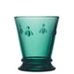 Green glass with embossed bee designs on a white background