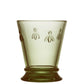 Green glass with bee designs on a white background
