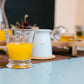 Glass of orange juice on a table with a blurred background
