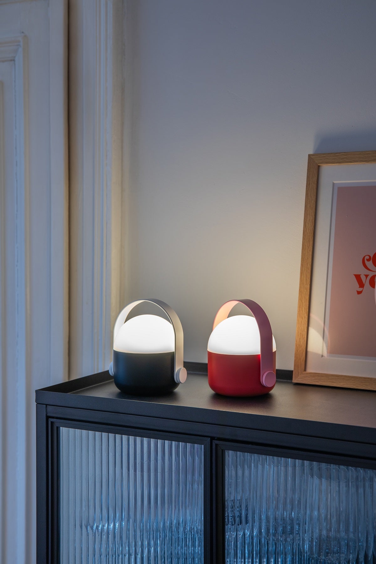 Round topped portable lamps on a drinks cabinet