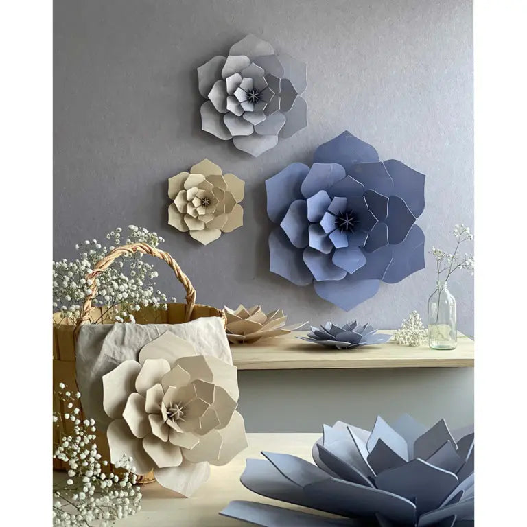 Decorative wooden flowers on a wall and surface with a neutral color palette.
