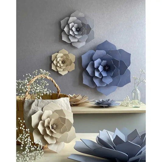 Decorative wooden flowers on a wall and surface with a neutral color palette.