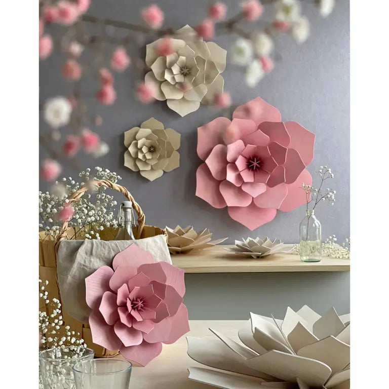 Wooden flowers on a wall and table against a gray background