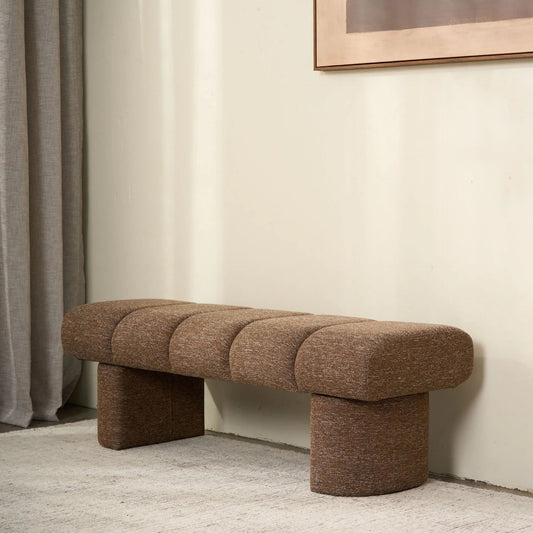 Brown textured bench against a neutral wall with a light gray carpet.